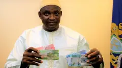 Gambia president Adama Barrow with di new note