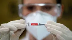 A nurse holds China"s Sinovac vaccine, a potential vaccine for the coronavirus disease, in Porto Alegre, Brazil, in August 2020