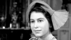 Princess Elizabeth with her baby daughter, Princess Anne, after the christening at Buckingham Palace