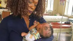 Iby Ikotidem with child