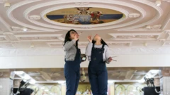Art graduate Sara Kamel Zekry (L) and her sister Christine work on a mural in a church in Aazaz in Sohag, Egypt - Saturday 15 January 2022