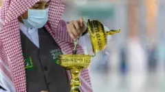 A handout picture provided by the Saudi ministry of media shows a member of the hajj staff burning incense at the Grand Mosque in the holy city of Mecca on 26 July 2020