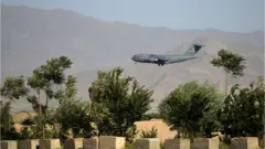 A US Air Force transport plane lands at the Bagram Air Base in Bagram on July 1, 2021
