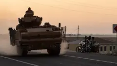A Turkish tank heads for the border with Syria as Operation Peace Spring begins