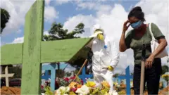 Valcenir Alves Ferreira reacts during the burial of her aunt who passed away due to the coronavirus disease, at the Parque Taruma cemetery in Manaus, Brazil, January 17th 2021