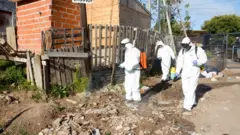Profissionais de saúde com máscaras durante operação em comunidade carente na Argentina