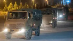 Turkish army soldiers drive towards the border with Syria near Akcakale in Sanliurfa province on 8 October
