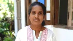 Yasawathie in front of her house
