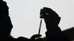 A healthcare worker prepares a dose of the Oxford/AstraZeneca coronavirus disease (COVID-19) vaccine, in Buenos Aires, Argentina June 4, 2021.