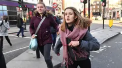 আতঙ্কিত মানুষ ঘটনাস্থাল থেকে পালিয়ে যাচ্ছেন।