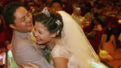 A couple hug during feast at a Chinese wedding ceremony