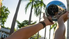 A person using a worldcoin orb