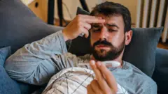 A man at home with Covid