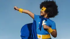A boy in superhero costume