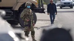 Olağanüstü halde askeri kamyon başında bekleyen bir asker.