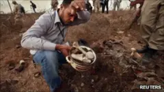 People have been collecting bones from the suspected site of the mass grave