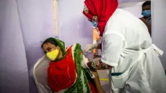 গার্মেন্টস শ্রমিককে টিকা দেয়া হচ্ছে।