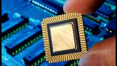Hand holding computer chip, close-up