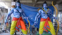 An Indian artist puts final touches to statues of Hindu God Lord Ram in Hyderabad on April 13, 2016