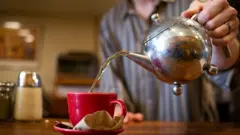 man making tea