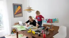 mother with daughter working from home
