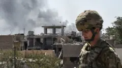 A US soldier advising Iraqi forces is seen in the city of Mosul on June 21, 2017