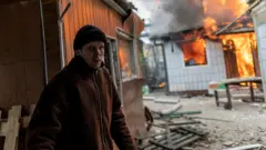 A resident in Irpin, near Kyiv, after the only escape route was shelled as Russian forces advance towards the capital