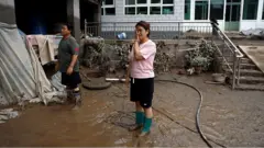 洪災後回家的涿州居民