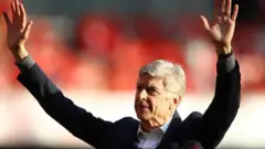 Arsene Wenger waving to the crowd after his final game in charge of Arsenal at Emirates Stadium