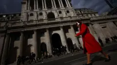 Woman walking past Bank of England