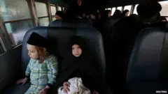 Lev Tahor members prepare to leave San Juan La Laguna on a bus