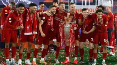Liverpool players celebrate with the Premier League trophy