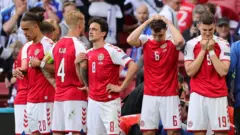 Denmark players react after Christian Eriksen collapses