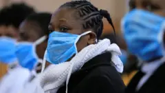 Attendees wearing masks at a Kenya church service.