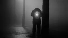 Man lighting a cigarette, Paris 1950