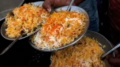 Plates of mutton biryani are served at an outside eatery in Lucknow on November 22, 2014
