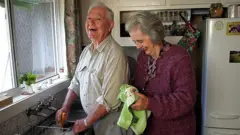 man and women in kitchen