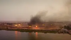 Flares at Iraqi oil field are shown burning gas next to villages