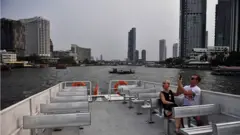 A lone couple take a tourist boat on the Chao Phraya River in Bangkok. 16 March