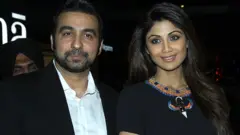 Indian Bollywood actress Shilpa Shetty (R) poses with her husband Raj Kundra as they attend the Indian premiere of the Hollywood film 'Fast & Furious 7' in Mumbai late April 1, 2015.
