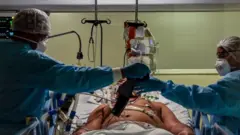 Medics attend to a Covid-19 infected patient in an intensive care unit in São Paulo, Brazil. Photo: April 2020