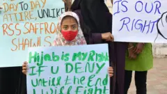 Muslim women hold placards during a demonstration after educational institutes in Karnataka denied entry to students for wearing hijabs, in Bangalore on February 7, 2022.