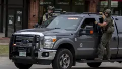 Image shows police officers with guns