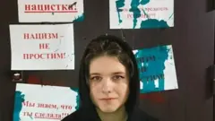 Darya Kheikinen in front of her vandalised door