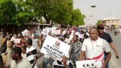 Di youths with di placards
