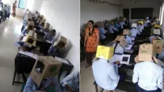 ተማሪዎች በፈተና ሰዓት የካርቶን ሳጥን ጭንቅላታቸው ላይ አጥልቀው ያሳያል
