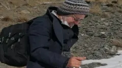 Kameel Ahmady walks through mountains while escaping Iran
