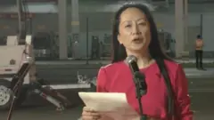 Meng Wanzhou waves to supporters at Shenzhen airport - 25/9