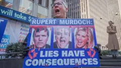 Man holding anti-Fox sign