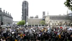 Protesters gather in Parliament Square, London